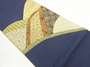 切り嵌め金彩曲線に華文・抽象模様織出し袋帯